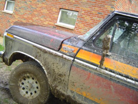 1979 Ford Bronco - This 1979 Ford Bronco is covered in mud, showing its off-road capabilities.