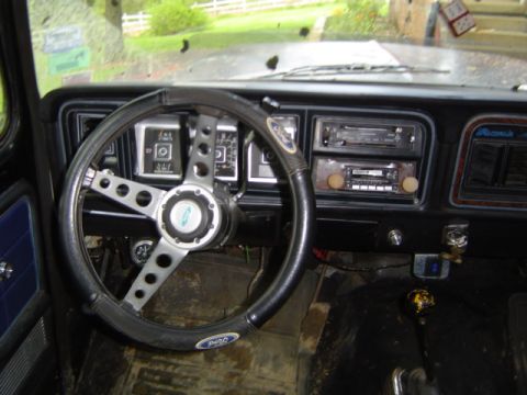 1979 Ford Bronco - Interior view of a 1979 Ford Bronco, an aftermarket steering wheel and dual radios.