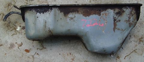 1986 Ford Bronco - This is an oil pan, likely from an engine, with visible red markings and signs of rust.