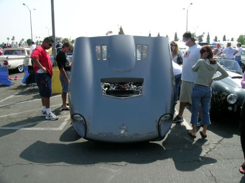 1993 Ford Probe - A car hood is open, revealing the engine, with several people observing the vehicle.