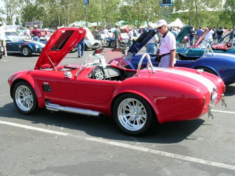 1993 Ford Probe - Red convertible sports car with hood open at a car show, with other vehicles and attendees present.