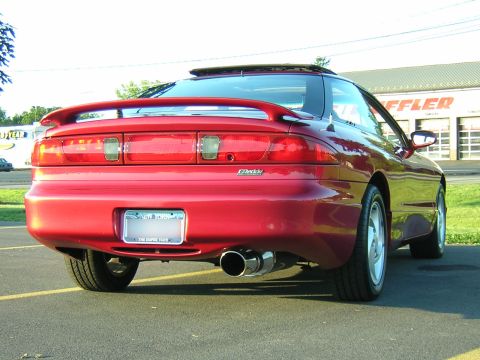 1995 Ford Probe - Rear view of a red 1995 Ford Probe GT, showing its spoiler and aftermarket exhaust system.