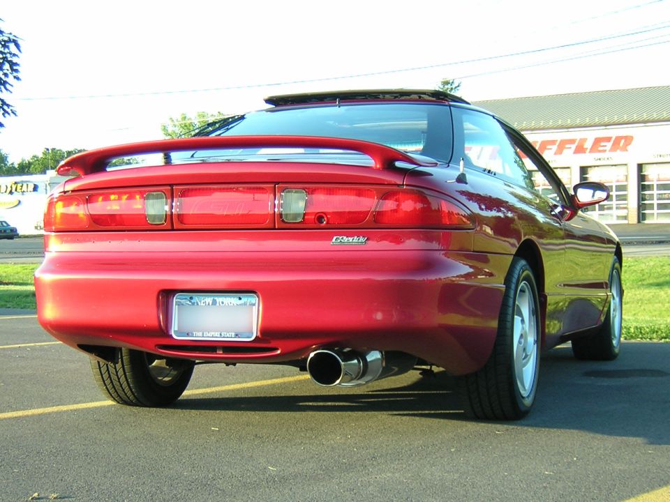 Red 1995 Ford Probe GT rear view with spoiler and dual exhaust