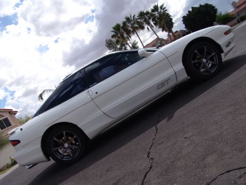 1995 Ford Probe - A white 1995 Ford Probe GT is captured from a three-quarter front angle on a cloudy day.