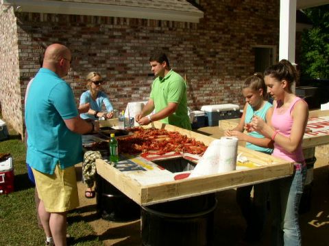 1995 Ford Bronco - A group of people are seen preparing a large quantity of crawfish at an outdoor gathering.