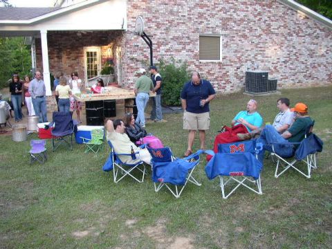 1995 Ford Bronco - A group of people enjoy a casual outdoor gathering in a suburban backyard.