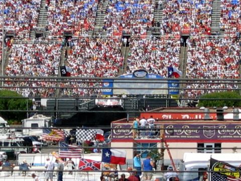 2000 Ford Crown Victoria - A wide view of a crowded stadium with various flags displayed.