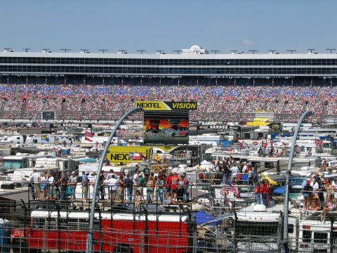 2000 Ford Crown Victoria - A busy race day scene with spectators and RVs filling the parking area.