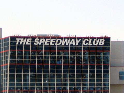 2000 Ford Crown Victoria - The Speedway Club building has large white text on its facade, with a Supermotors logo visible at the bottom.