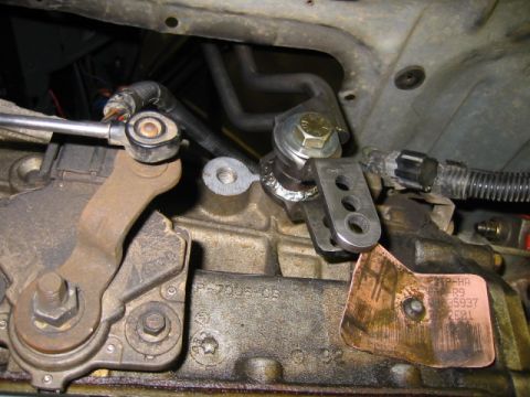 1992 Ford Bronco - Close-up view of the transfer case linkage, showing a '92 date stamp and a copper identification tag.