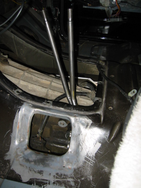 1992 Ford Bronco - This photo shows the interior of a vehicle's transmission tunnel, focusing on the area around the gear shifter mechanism.