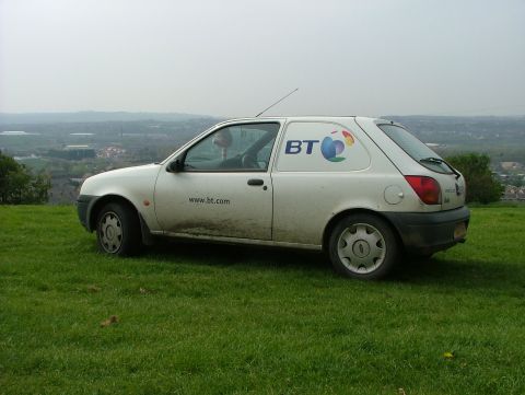 2001 Ford Fiesta - Side view of a white 2001 Ford Fiesta panel van with BT branding, parked outdoors.