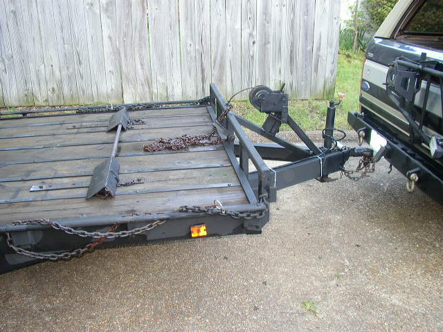 Trailer hitch with chains and winch, attached to a vehicle bumper