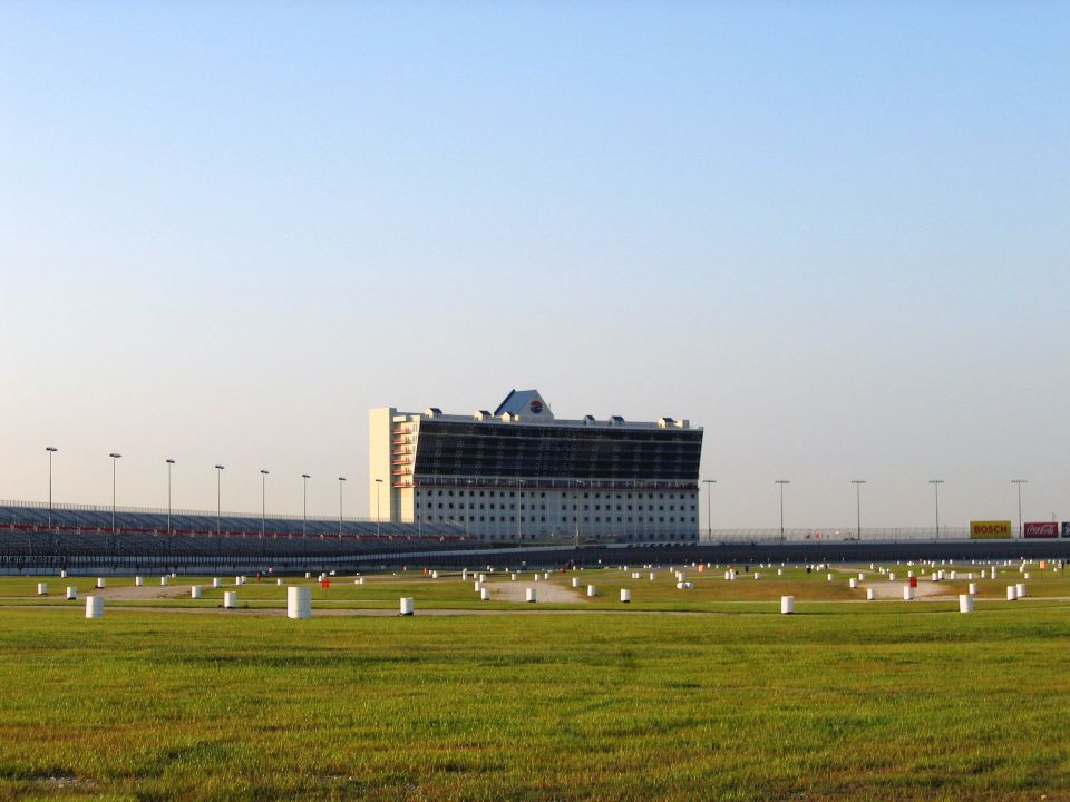 Wide shot of Texas Motor Speedway grandstands and field with a clear blue sky