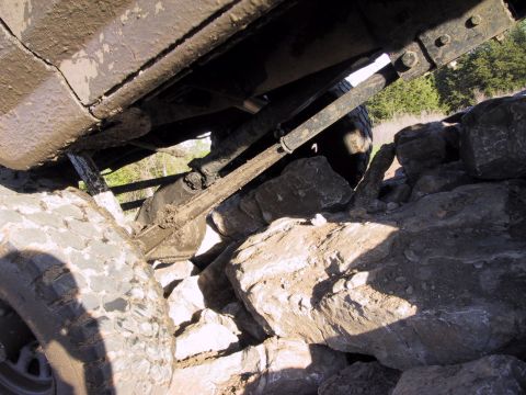 1983 Ford Bronco - The undercarriage of a 1983 Ford Bronco navigates a rocky obstacle course.