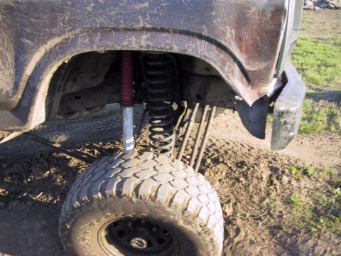 1983 Ford Bronco - The vehicle's suspension system is modified for off-road use, with large tires and a lifted stance.