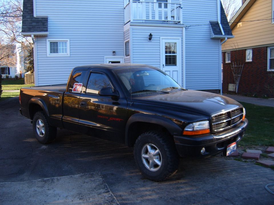 Black Dodge Dakota pickup truck, 3q-front view