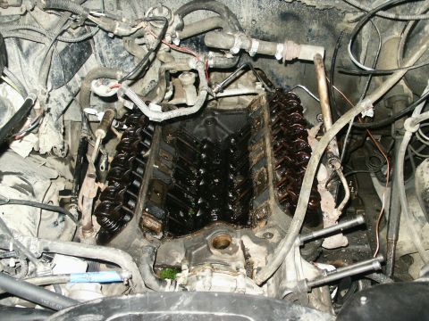 1991 Ford Bronco - Close-up view of a disassembled V8 engine, showing internal components and surrounding wiring.