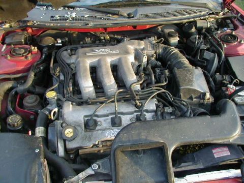 1993 Ford Probe - The V6 engine is visible in the engine bay, with some Ford branding present on the engine block.