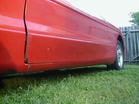 1993 Ford Probe - Side view of a 1993 Ford Probe, focusing on the door and fender area.
