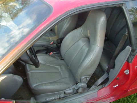 1993 Ford Probe - The interior of a 1993 Ford Probe shows gray leather seats and a red exterior.