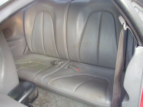 1993 Ford Probe - The rear interior of a car, showing the gray leather seats and seatbelts.