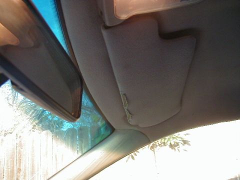 1993 Ford Probe - Interior view of a car's sun visor and rearview mirror, with visible damage to the visor.