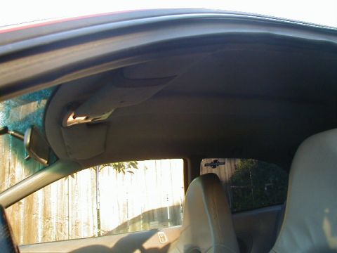 1993 Ford Probe - Interior view of a car, focusing on the headliner and a seat, with a sticker on the rear window.
