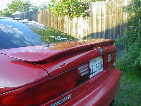 1993 Ford Probe - Rear view of a red 1993 Ford Probe, a spoiler and a California license plate.