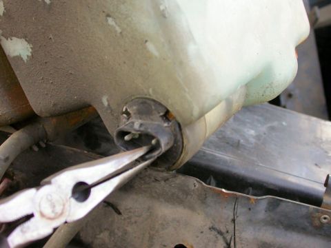 1990 Ford Bronco - Now this is a little PIA! Use the screwdriver to bend/pry the washer pump inside the unit to loosen it. (there are three 'grooves' in the p…