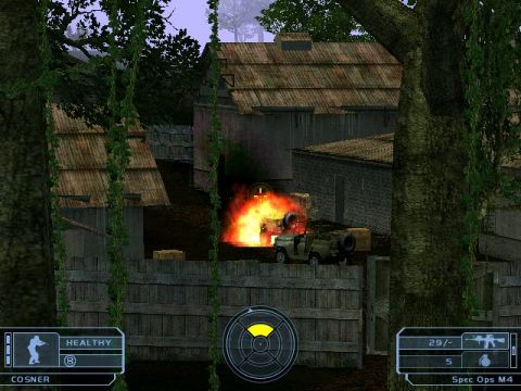 1988 Ford Bronco - A military jeep is on fire in a scene with buildings and trees. Game interface elements are visible.