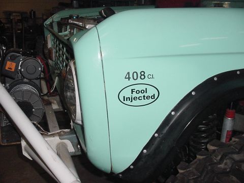 1969 Ford Bronco - A mint green vehicle fender displays a sticker indicating '408 C.I. Fool Injected'.