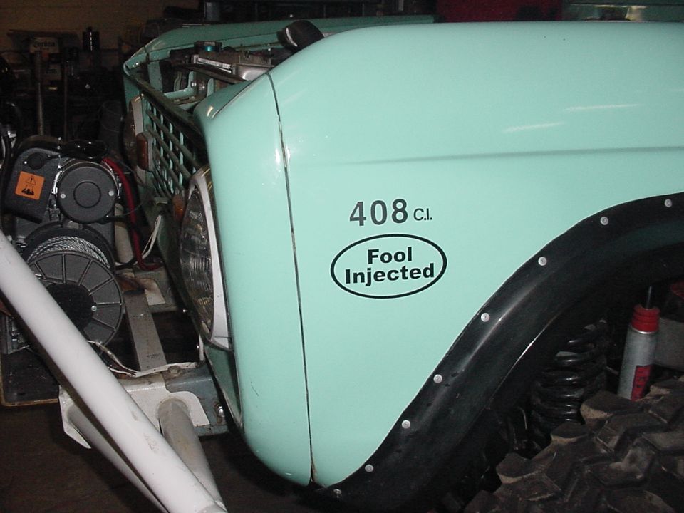 Mint green vehicle fender with '408 C.I. Fool Injected' sticker