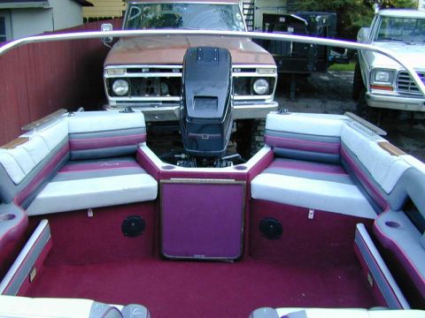 1989 Maxum 2000/XC - Interior view of a boat with two trucks parked behind it.