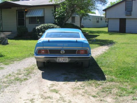 1972 Ford Mustang - This blue Ford Mustang has a distinctive rear end with horizontal taillights and dual exhaust pipes.