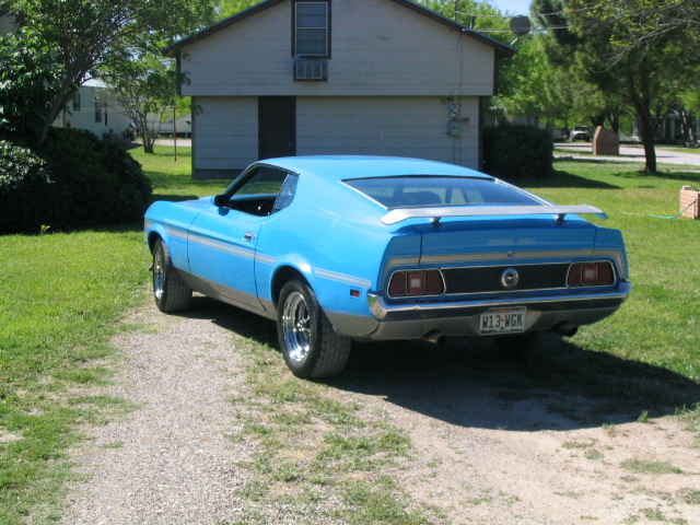Blue 1971 Ford Mustang coupe with a spoiler, seen from the rear
