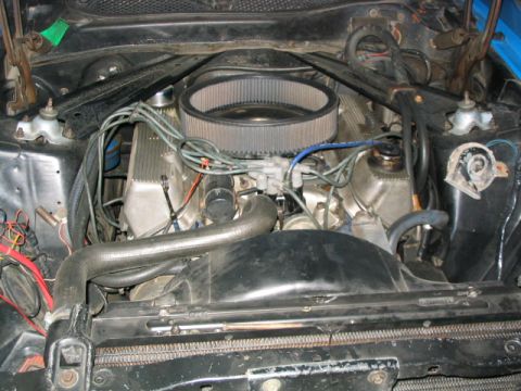 1972 Ford Mustang - Close-up view of a V8 engine bay, showing the air intake and cooling fan.