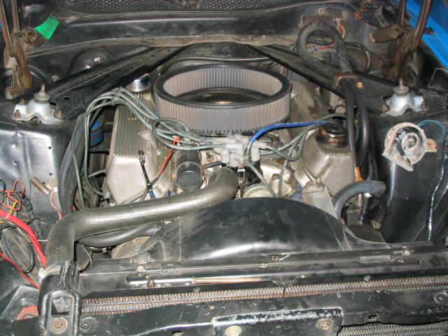 Engine bay with V8 engine, air filter, and radiator fan