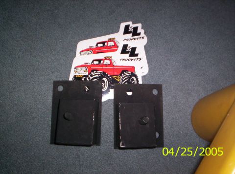 1985 Ford Bronco - The photo shows two black metal brackets and two stickers red monster trucks from LL Products.