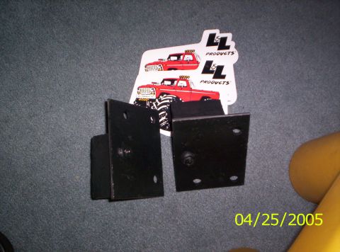 1985 Ford Bronco - Two black metal brackets are shown with stickers of red trucks and a date stamp.