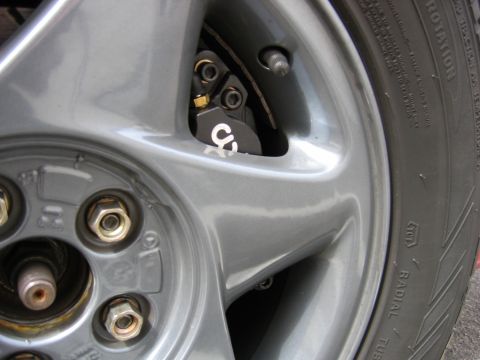 1995 Ford Taurus - Detail of a car wheel and brake caliper assembly with a visible 'CS' marking.
