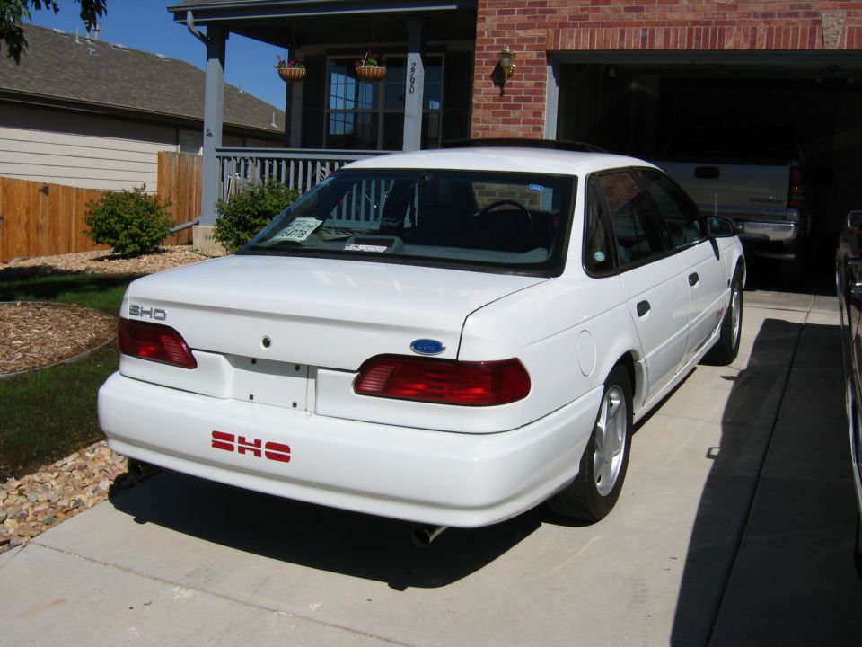1992 Ford Taurus SHO rear view, white paint, red SHO badge on bumper