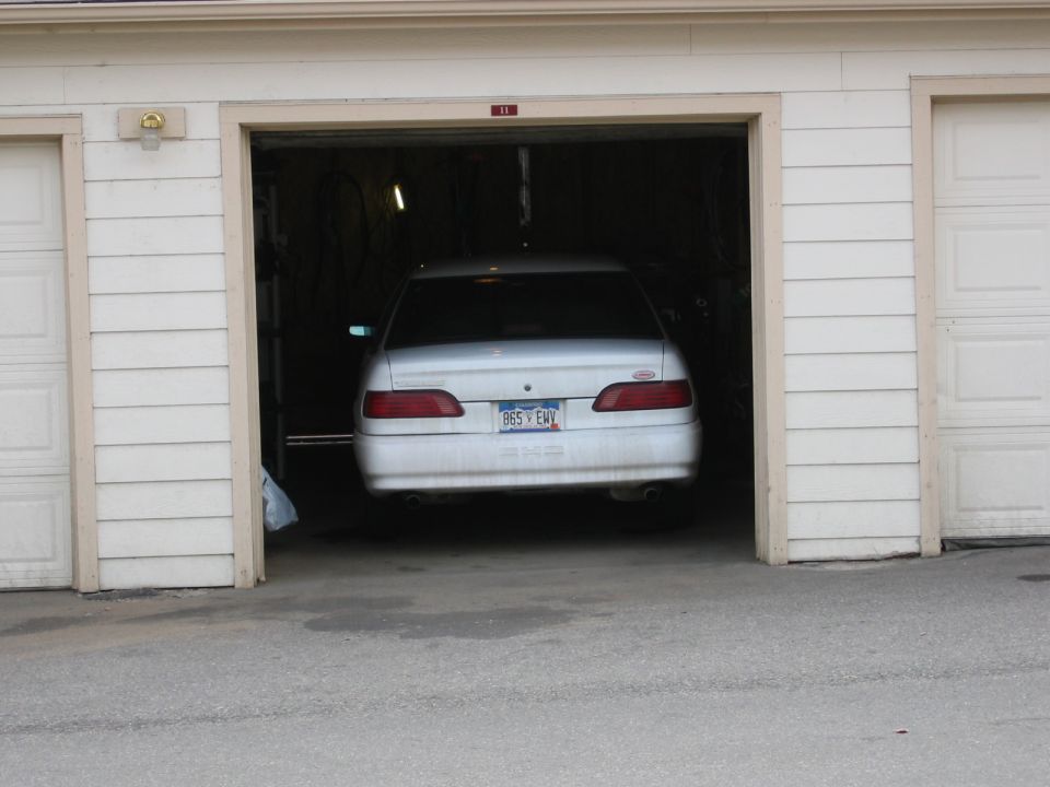 1992 Ford Taurus sedan, white, parked in a garage, rear view