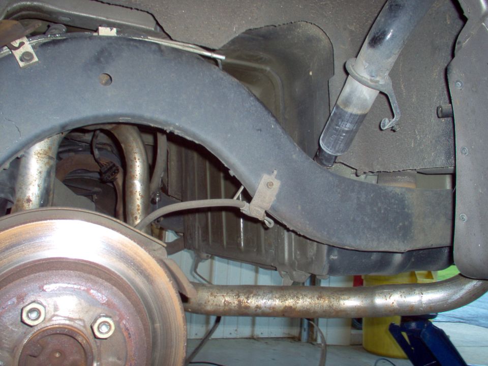 Removing the gas tank wasn't necessary to install the muffler - it fits equally well with the tank in.