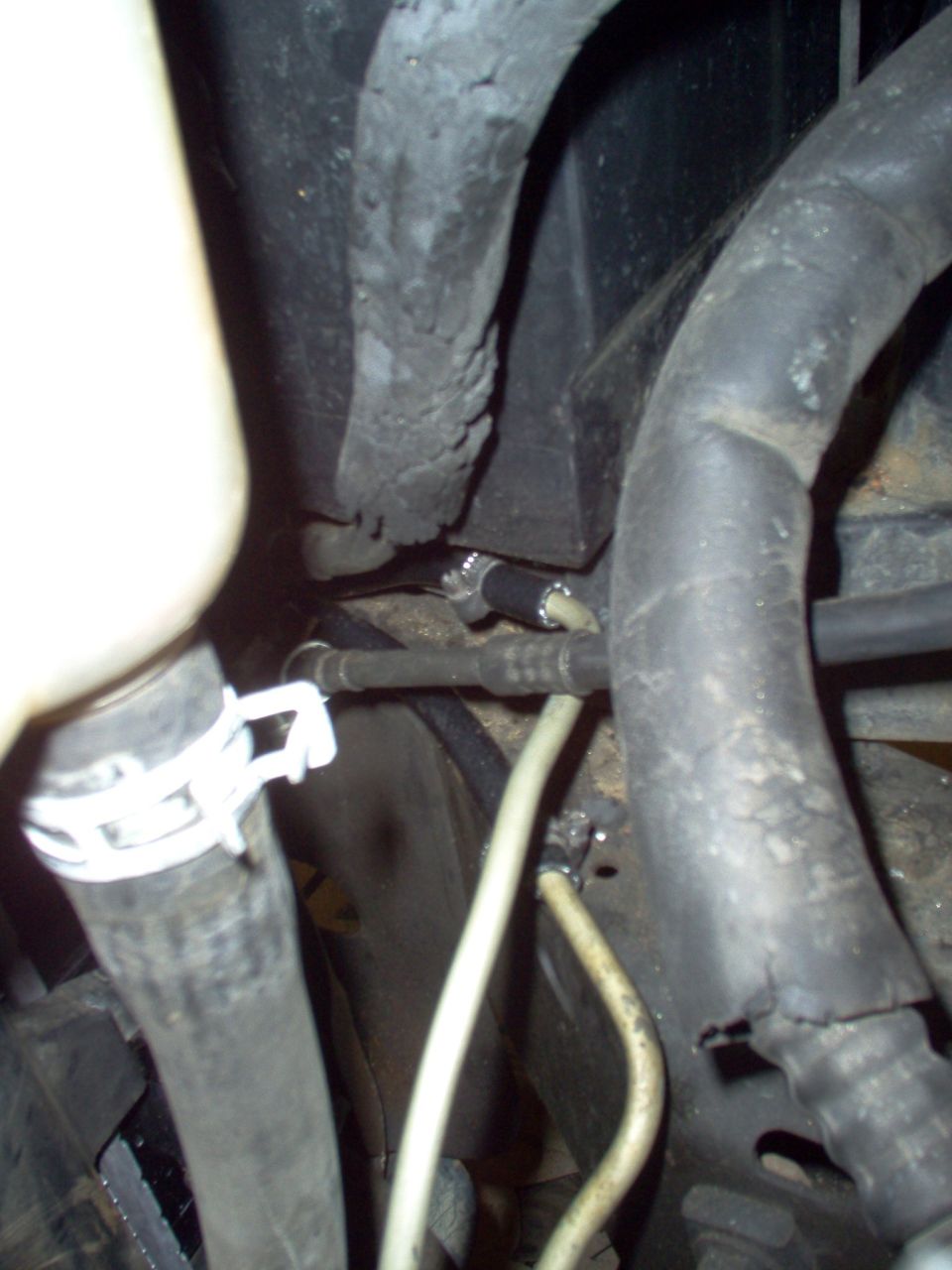 The hoses meet the original '94 hard lines at the side of the battery tray.