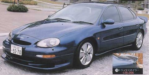 1999 Ford Taurus - This sedan features a sporty body kit and custom wheels, with a license plate from Japan.