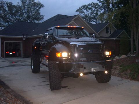1989 Ford Bronco - Front view of a black Ford F-650 truck parked in a driveway at dusk.