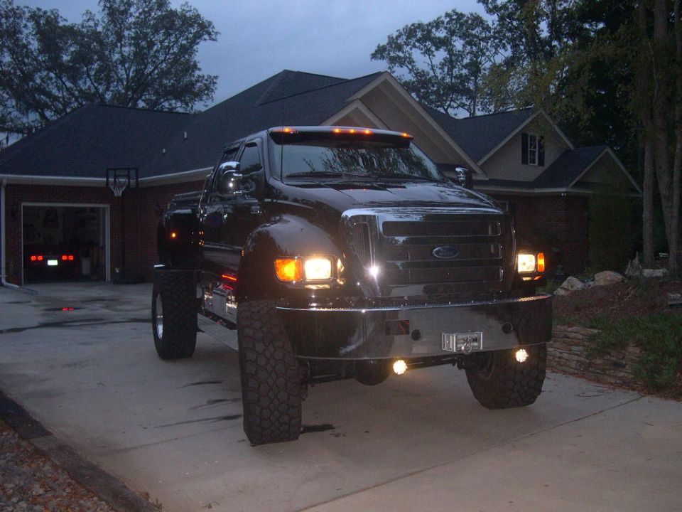 Black Ford F-650 truck parked in driveway, front view