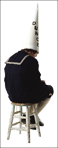 1968 Ford Mustang - A person wearing a dunce cap and a sailor uniform sits on a stool, facing away from the camera.