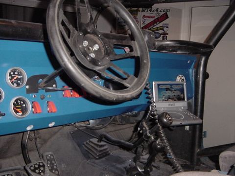 1971 Ford Bronco - Customized Jeep CJ interior with auxiliary gauges and a small display screen.
